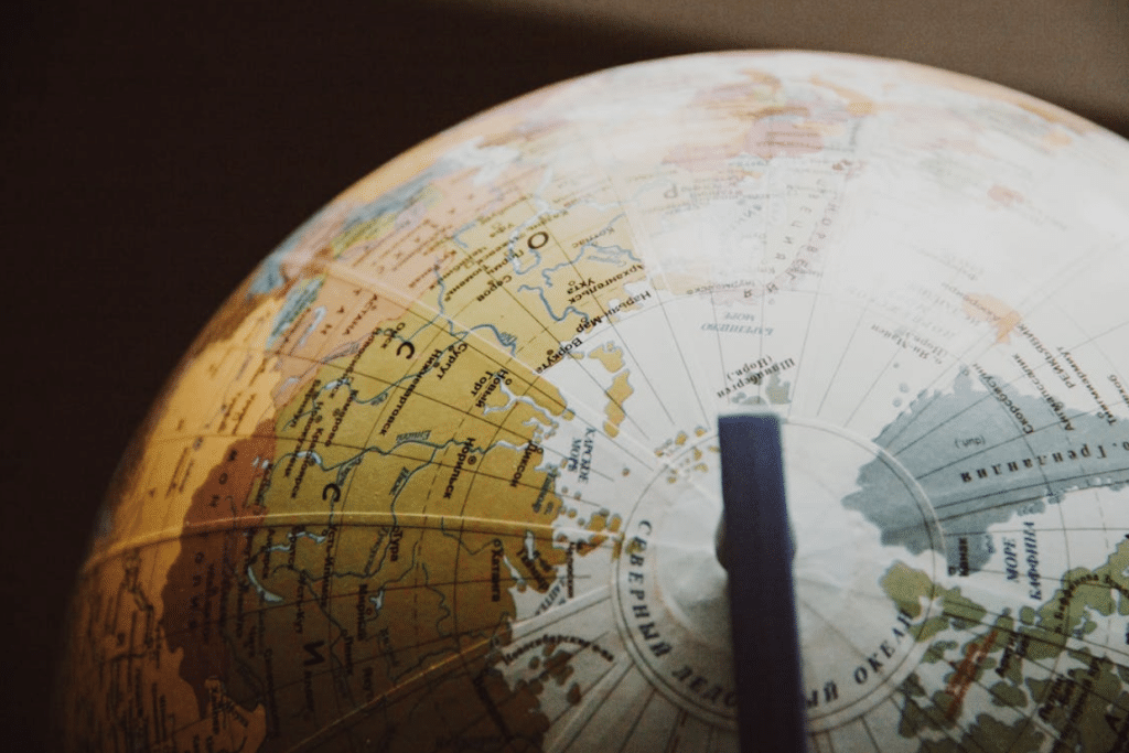 Close-up of a globe showing detailed topography and political boundaries in warm colors.